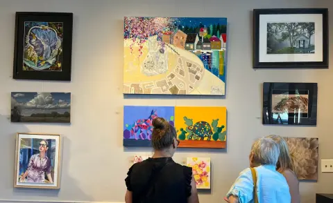 Visitors viewing Kristin Sue Kim artwork in a recent gallery exhibition